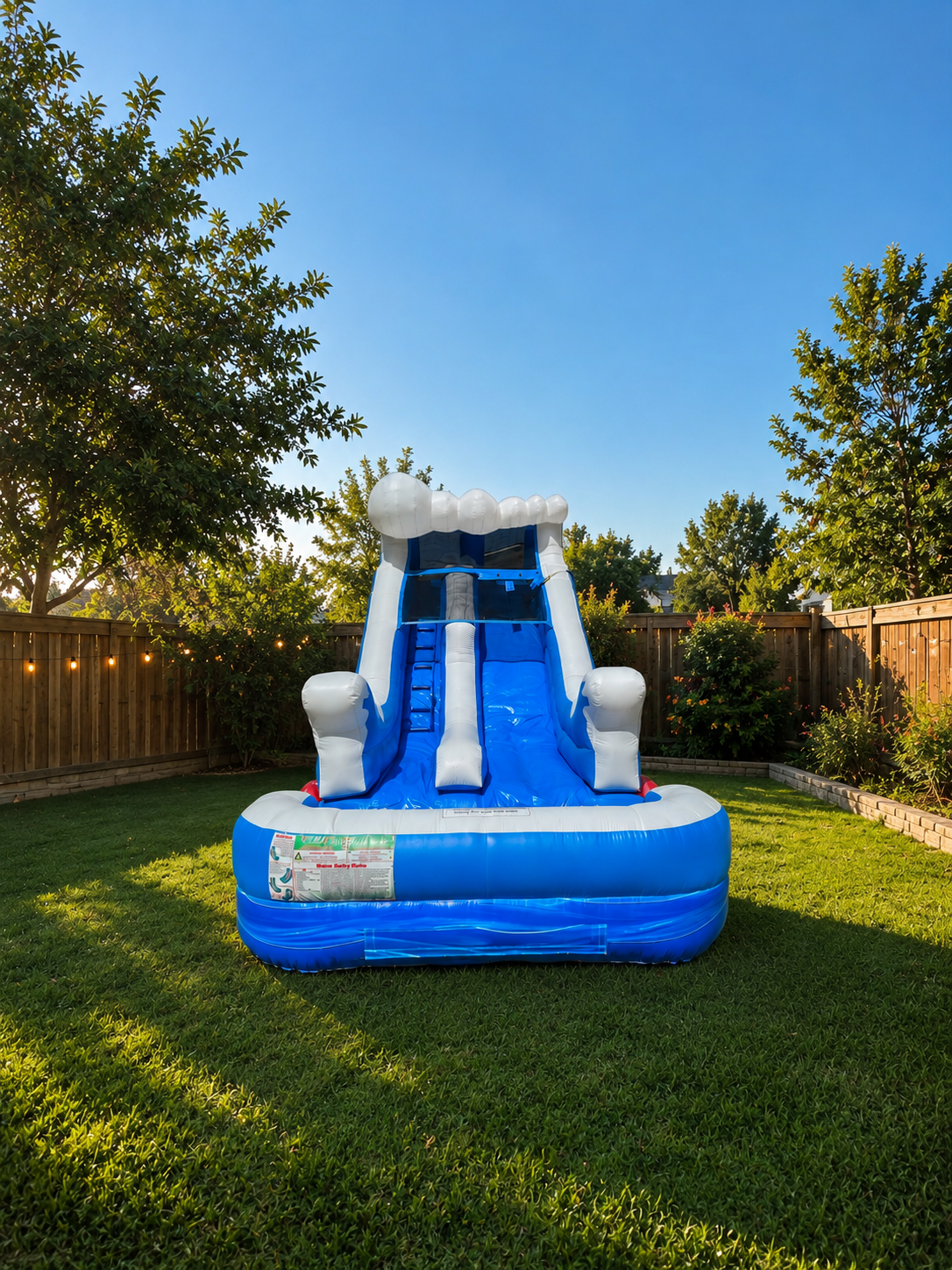 Blue and white inflatable water slide with splash pool